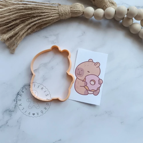Capybara fánkkal körvonal sütikiszúró